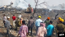 Rescue personnel and local residents gather near a firecracker plant following an explosion at Harda district in India's Madhya Pradesh state on Feb. 6, 2024.