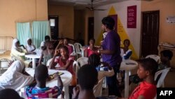 FILE - Young girls listen to an educational talk at the Bada Primary Health Centre in Lagos, Nov. 11, 2018. The "9ja Girls" is a program aimed at helping young Nigerian girls prepare for adulthood through educational programs and family planning.