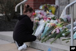 Linda Shields leaves flowers in front of the West York Police Department after a police officer was killed responding to a shooting at UPMC Memorial Hospital in York, Pa., on Feb. 22, 2025.