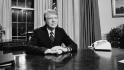 FILE - President Jimmy Carter is seated at his desk in the Oval Office prior to delivering his message on energy, April 19, 1977, Washington.