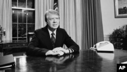 (FILE) President Jimmy Carter is seated at his desk in the Oval Office prior to delivering his message on energy, April 19, 1977, Washington.