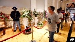 Friends and fans file past flowers and his famed guitar "Lucille," on their way to B.B. King's coffin during a public viewing, May 29, 2015 in the B.B. King Museum and Delta Interpretive Center in Indianola, Mississippi.