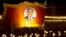 A float with a portrait of late North Korean leader Kim Il Sung passes by North Korean students taking part in a torch light march held in conjunction with the 70th anniversary of North Korea's founding day celebrations in Pyongyang, North Korea, Sept. 10