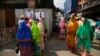 FILE - Indian Dawoodi Bohra women walk past others shopping for clothes in a Bohra neighborhood in Mumbai, India, on Feb. 21, 2016. The Dawoodi Bohra Muslim sect practices the ritual of "female circumcision," called female genital mutilation in a March 8, 2024, U.N. report.