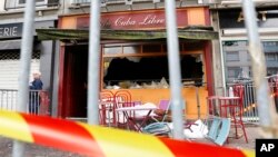 A police officer stands outside the bar where a fire broke out in Rouen, Normandy, western France, Aug. 6, 2016.