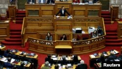 Greek Prime Minister Alexis Tsipras addresses lawmakers during a parliamentary session before a budget vote in Athens, Greece, Dec. 18, 2018.