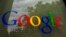FILE - The Google logo on a window at the company's headquarters in Mountain View, Calif. 