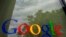 FILE - The Google logo on a window at the company's headquarters in Mountain View, Calif. 