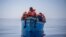 A group thought to be migrants from Tunisia aboard a precarious wooden boat waiting to be assisted by a team of the Spanish NGO Open Arms, around 20 miles southwest from the Italian island of Lampedusa, in Italian SAR zone. Taken 7.29.2021