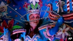 A maid from the royal court of Endymion throws beads as the Krewe of Endymion Mardi Gras parade rolls through New Orleans, Feb. 6, 2016. 