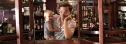 T. Cole Newton with his child at his bar. Newton began hosting presidential debate watch parties at his New Orleans, Louisiana bar in 2012. (Courtesy/Twelve Mile Limit)