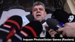 Romanian Prime Minister and presidential candidate Marcel Ciolacu answers questions from the media before the announcement of the first exit polls during the first round of the presidential election in Bucharest, Nov. 24, 2024. 