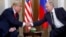 FILE - U.S. President Donald Trump and Russian President Vladimir Putin shake hands at the beginning of a meeting in Helsinki, Finland, on July 16, 2018.