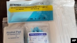In this image provided by the U.S. Immigration and Customs Enforcement, March 24, 2020, shows unapproved COVID-19 tests that were seized from the DHL Express Consignment Facility at JFK Airport in the Queens borough of New York.