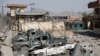 Damaged police vehicles are seen at the site of a blast in Kabul, Afghanistan, Aug. 7, 2019. 