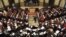 Syrian lawmakers gather during a session to vote for a new election law, at the Syrian parliament in Damascus, Syria, March 11, 2014.