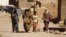 Indigenous Sahrawi women walk through Al Smara desert refugee camp in Tindouf, southern Algeria, March 4, 2016. 