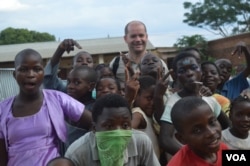 Director of Jacaranda School, Luc Deschamps with students (VOA/L. Masina)