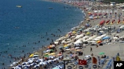 FILE - Local and foreign tourists fill Konyaalti beach in Antalya, southern Turkey, Aug. 29, 2006. The tourism industry has taken a big hit this year because of security threats.