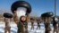 People's Liberation Army (PLA) soldiers pour snow from a tire onto their head during a training session in Heihe, Heilongjiang province, December 24, 2014.
