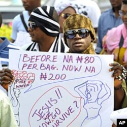 A protester carries a placard during a rally against fuel subsidy cuts in Nigeria's capital, Abuja, January 6, 2012.