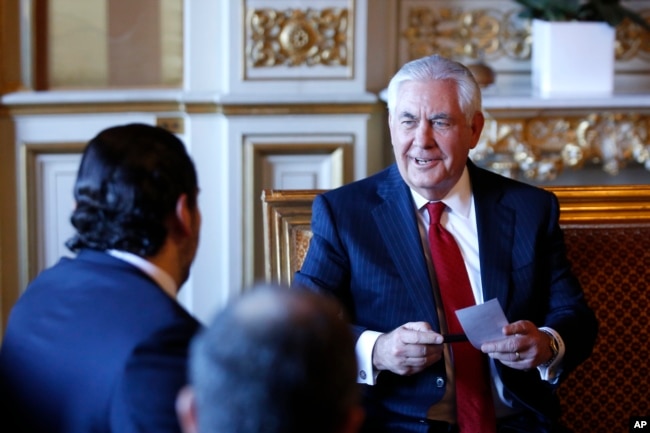 Lebanon's Prime Minister Saad Hariri, left, meets U.S. Secretary of State Rex Tillerson before a gathering of world diplomats in Paris, Dec. 8, 2017.