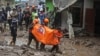 Rescuers carry the body of a person killed in a landslide in Karo, North Sumatra, Indonesia, Nov. 25, 2024. 