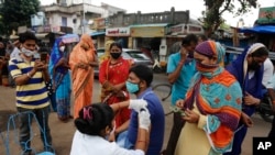 Seorang petugas medis tampak tengah memberikan vaksin COVID-19 kepada warga dalam program vaksinasi yang dijalankan di Ahmedabad, India, pada 31 Agustus 2021. (Foto: AP/Ajit Solanki)