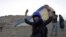 Afghan paraglider Leeda Ozori, 21, prepares to practice, outside Kabul, September 17, 2015.