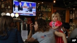 Christine Fox and her daughter Emmylou Fox from Washington state wait for the results of the U.S. midterm elections during a gathering organized by Democrats Abroad in Beijing, China, Nov. 7, 2018.