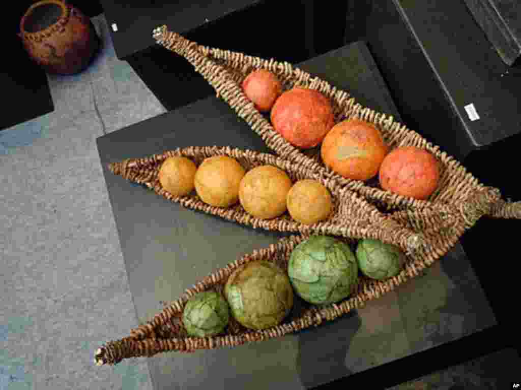 Baskets by Christine Adcock of Santa Barbara, California contain colorful spheres, giving a peas-in-a-pod appearance.