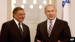 U.S. Defense Secretary Leon Panetta, left, smiles as Israel's Prime Minister Benjamin Netanyahu speaks, in the Prime's Minister office in Jerusalem, Oct. 3, 2011.