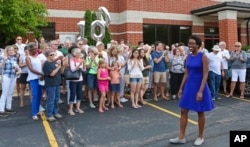 FILE - Rookie Democratic candidate Lauren Underwood greets supporters at the opening of her campaign office in St. Charles, Ill., July 29, 2018. If elected to the U.S. House in the midterms, Underwood would be the first woman and first minority to represent the predominantly white district once represented by GOP House Speaker Dennis Hastert.