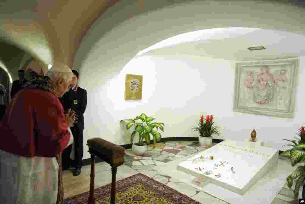 Pope Benedict XVI prays before the tomb of Pope John Paul II in 2011 (AP Photo/L'Osservatore Romano)