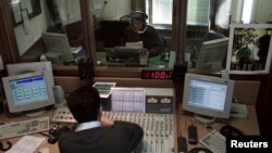 FILE - A Vatican Radio reporter speaks during a live program, April 10, 2001.