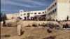 Civilians search notorious Syrian prison for loved ones 