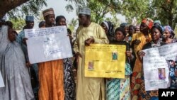 FILE—Parents and relatives hold portraits of their girls during a commemoration five years after they were abducted by Boko Haram Jihadists group on April 14, 2019 at the Chibok Local Government.