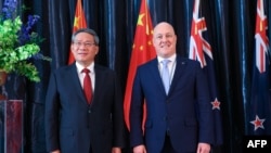 Chinese Premier Li Qiang and New Zealand Prime Minister Christopher Luxon pose for photos prior to their meeting at Government House in Wellington on June 13, 2024. Li moved on to Australia on June 15.