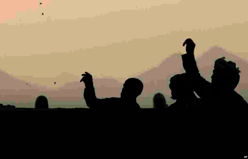 Muslim pilgrims cast stones at a pillar, symbolizing the stoning of Satan, a rite of the annual Hajj, in Mina near the holy city of Mecca, Saudi Arabia, Oct. 16, 2013. 