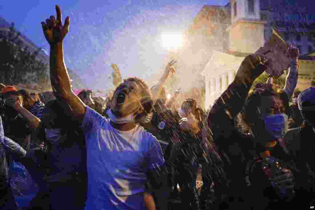 Demonstrators protest during a thunderstorm on Thursday, June 4, 2020, near the White House in Washington, over the death of George Floyd. Floyd, a 46-year-old black man, died on May 25 after being restrained by Minneapolis police officers. (AP Photo/Evan Vucci)&nbsp;