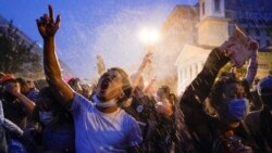 Demonstrators protest, Thursday, June 4, 2020, near the White House in Washington, over the death of George Floyd, a black man who was in police custody in Minneapolis. Floyd died after being restrained by Minneapolis police officers. (AP Photo/Evan Vucci