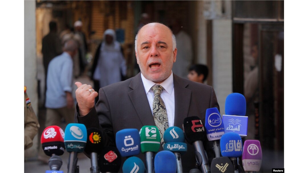 FILE - Iraqi Prime Minister Haider al-Abadi speaks to reporters in the Shi'ite holy city of Najaf, south of Baghdad, Oct. 20, 2014.