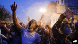 Demonstrators protest during a thunderstorm on Thursday, June 4, 2020, near the White House in Washington, over the death of George Floyd. Floyd, a 46-year-old black man, died on May 25 after being restrained by Minneapolis police officers. (AP Photo/Evan Vucci)&nbsp;