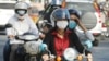 Cambodians wear masks to avoid the contact of coronavirus in Phnom Penh, Cambodia, Tuesday, Jan. 28, 2020. (AP Photo/Heng Sinith)