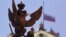 A sculpture of a double-headed eagle, a national symbol of Russia, is seen in front of a Russian national flag flying at half-mast on the roof of the State Hermitage Museum in St. Petersburg, Nov. 1, 2015.