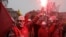 Union members hold safety flares during a demonstration in front of the entrance of the Paris auto show in Paris, Tuesday, Oct. 9, 2012. 