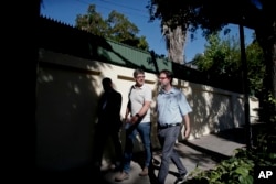 James Hamilton, left, and Jose Andres Murillo arrive to meet with Jordi Bertomeu, a Spanish priest, about sexual abuse committed by parish priest Fernando Karadima, in Santiago, Chile, Feb. 21, 2018.