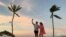 FILE - A couple videochats on their smartphone on the beach in the aftermath of Hurricane Matthew near Nassau, Bahamas, Oct. 9, 2016.