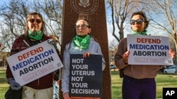 FILE - Members of the Women's March group protest in support of access to abortion medication outside the Federal Courthouse on March 15, 2023, in Amarillo, Texas.