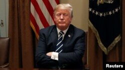 U.S. President Donald Trump waits for reporters to leave the room after speaking about his summit with Russia's President Putin during a meeting with members of the U.S. Congress at the White House in Washington, July 17, 2018. 